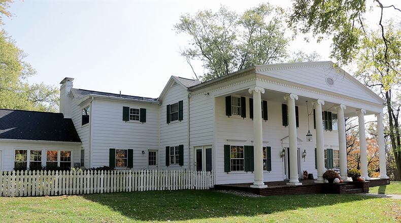 The 2-story has more than 4,000 sq. ft. of living space with 5 bedrooms and 3 full baths. A brick walkway and steps lead up from the circular driveway to the 2-story front porch with windows adorned with wrought-iron accented shutters and six columns supporting the A-frame roofline. CONTRIBUTED PHOTO BY KATHY TYLER