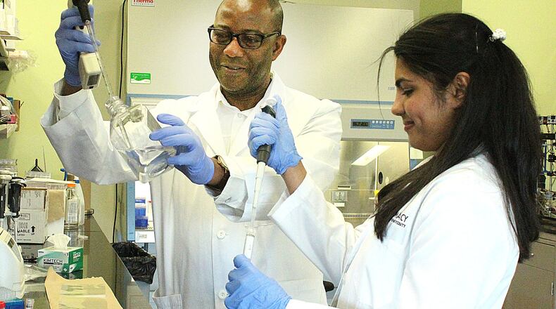 Cedarville University pharmacy student (right) Christy Varghese and Samson Amos Ph.D. practice taking samples in the pharmacy lab. JEFF GUERINI/STAFF