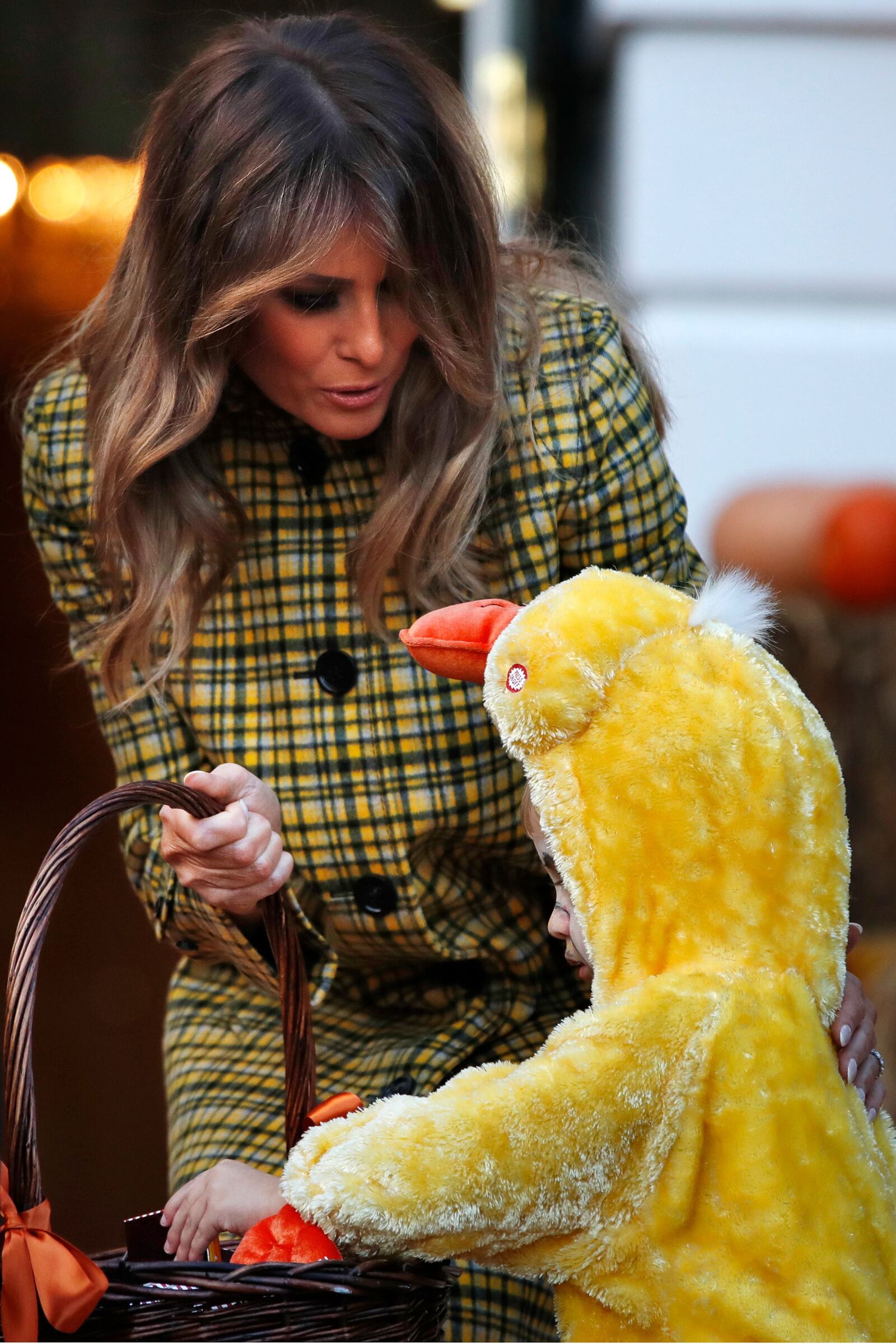 First lady Melania Trump gives candy to a child during a Halloween trick-or-treat event at the White House, Sunday, Oct. 28, 2018, in Washington. (AP Photo/Jacquelyn Martin) ORG XMIT: DCJM114