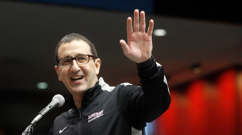 Jim Jabir, University of Dayton women’s basketball head coach, waves to the thousands of fans who attended a public celebration of the men’s and women’s basketball teams at UD Arena. LISA POWELL / STAFF FILE