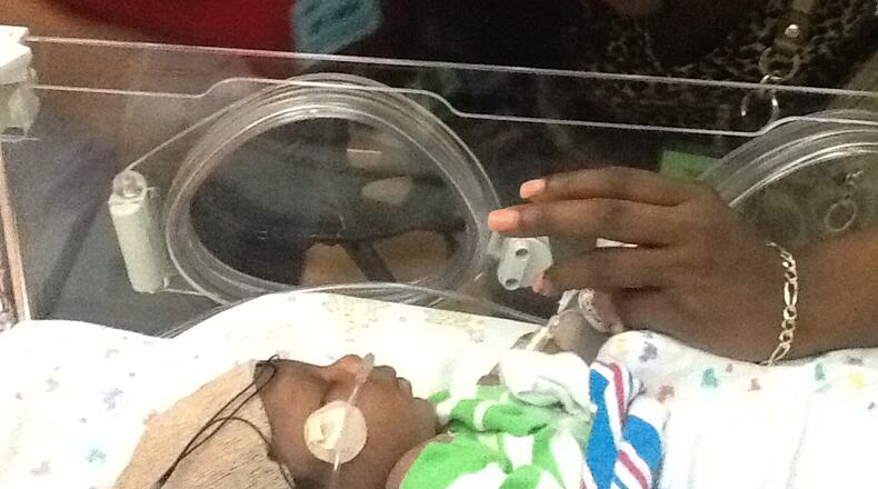 Christopher Foster grabs the finger of a family member (Contributed photo)