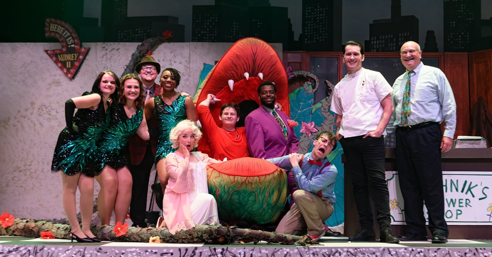 Left to right: Vance Hagenbuch (Crystal), Adelaide Powell (Ronnette), Anthony Reed (Customer), Jacqueline Grayson (Chiffon), Chloe K. Terrey (Audrey), Keith Board (The Plant), Antwan Terrell (Voice of the Plant), Brady Castillo (Seymour Krelborn), Jeremy Moeller (Orin Scrivello), and Steve Morgenstern (Mr. Mushnick) in "Little Shop of Horrors" produced by The John Legend Theater. Photo courtesy of The John Legend Theater