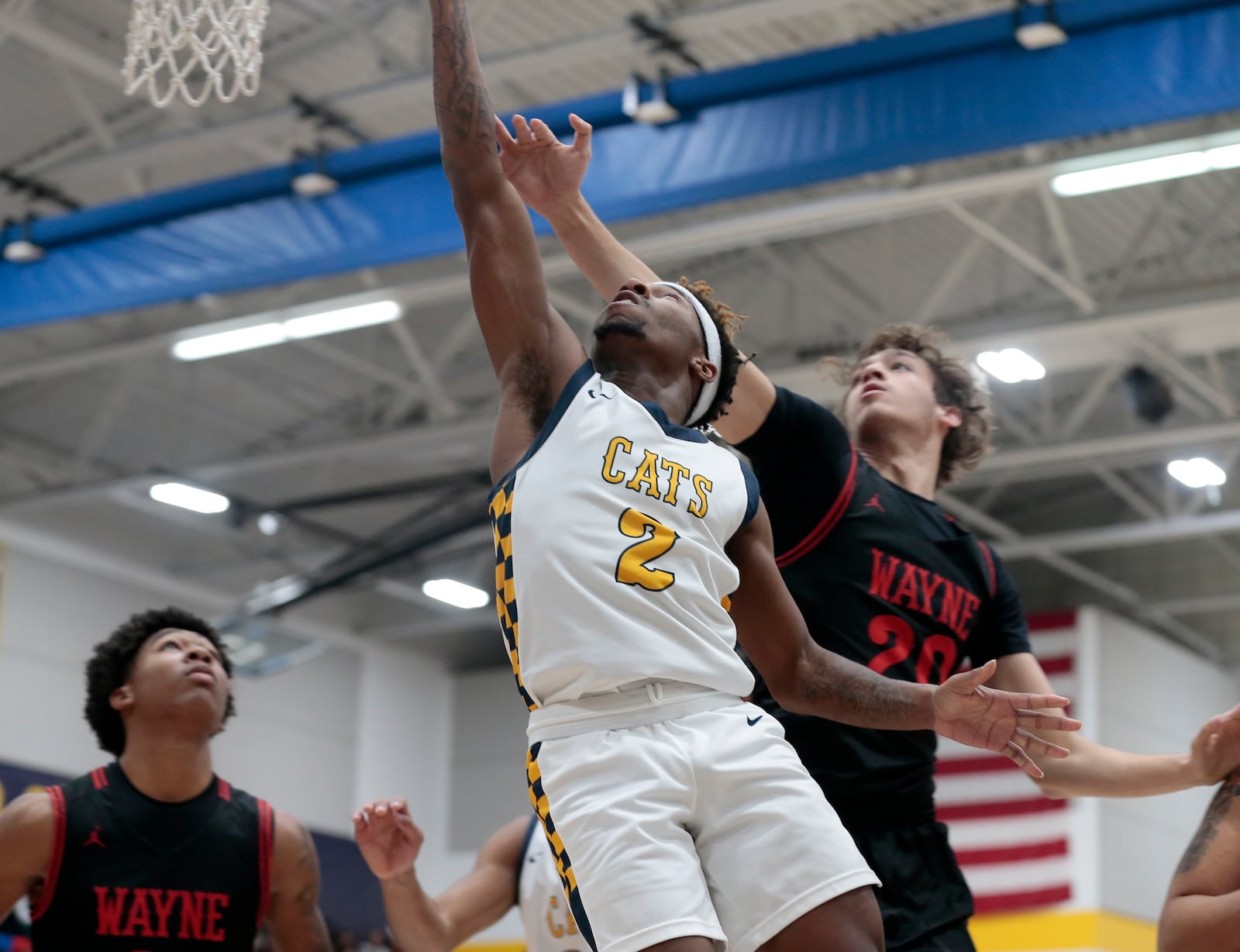Wayne High School senior Alphonso Ward (20) leaps to block a shot by Springfield senior Sherrod Lay during their Greater Western Ohio Conference boys basketball game on Friday, Jan. 2, 2026. The Warriors won 55-42. STEVEN WRIGHT / STAFF
