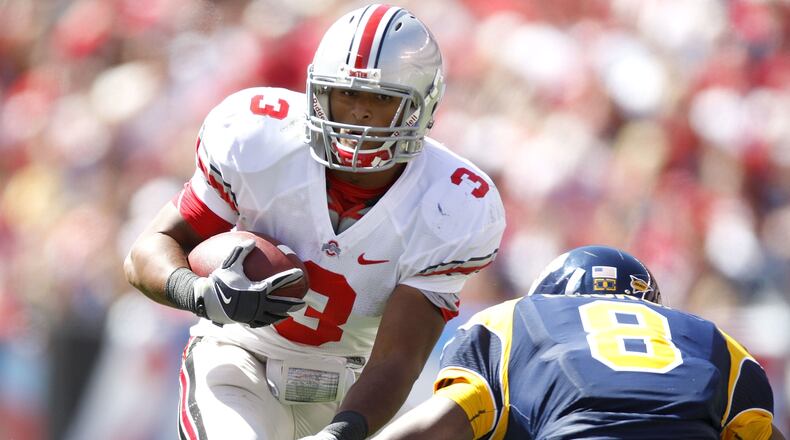 CLEVELAND - SEPTEMBER 19: Brandon Saine #3 of the Ohio State Buckeyes tries to get around the tackle of Berry Church #8 of the Toledeo Rockets on September 19, 2009 at Cleveland Browns Stadium in Cleveland, Ohio. Ohio State won the game 38-0. (Photo by Gregory Shamus/Getty Images)