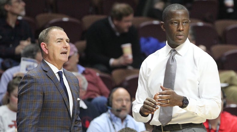 Dayton’s Donnie Jones, left, and Anthony Grant coach during a game against Tulsa on Sunday, Dec. 16, 2018, at Mohegan Sun Arena in Uncasville, Conn. David Jablonski/Staff