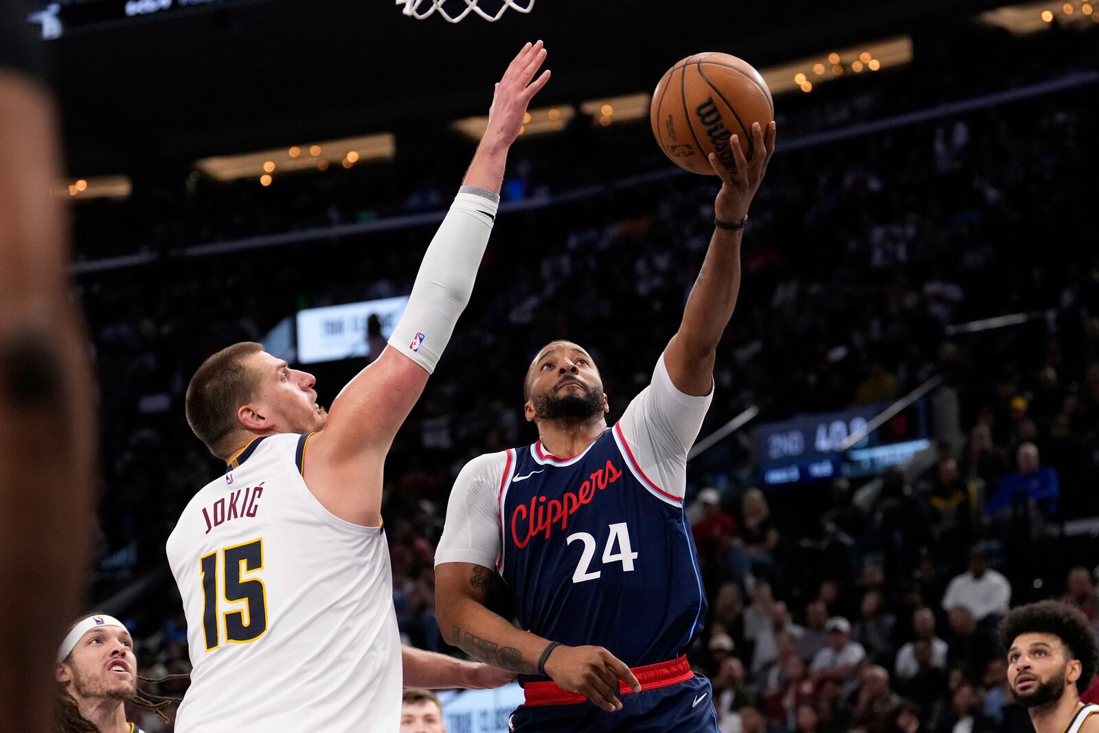 Los Angeles Clippers guard Norman Powell (24) shoots as Denver Nuggets center Nikola Jokic (15) defends during the first half in Game 4 of an NBA basketball first-round playoff series Saturday, April 26, 2025, in Inglewood, Calif. (AP Photo/Mark J. Terrill)