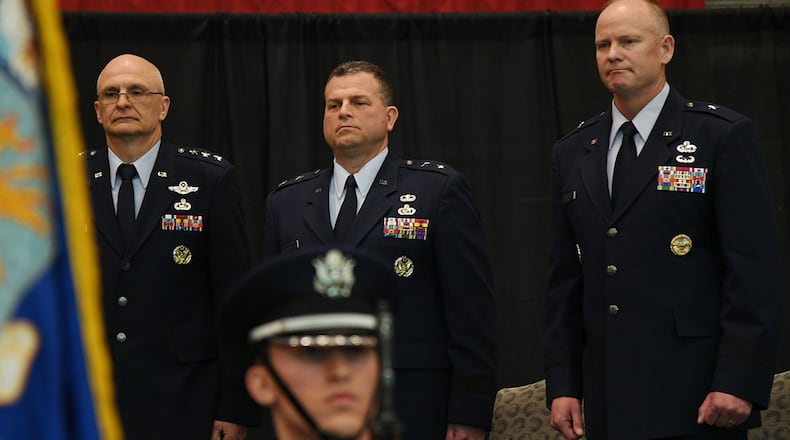Brig. Gen. Michael Schmidt (right) takes leadership of the Command, Control, Communications, Intelligence and Networks directorate at Hanscom Air Force Base, Mass., April 13 from Maj. Gen. Dwyer Dennis (center), who is retiring, during a ceremony hosted by Lt. Gen. Arnold Bunch (left), military deputy of the Office of Assistant Secretary of Air Force for Acquisition at the Pentagon. The change of leadership ceremony was held at the Hanscom Aero Club hangar. (U.S. Air Force photo/Linda LaBonte Britt)