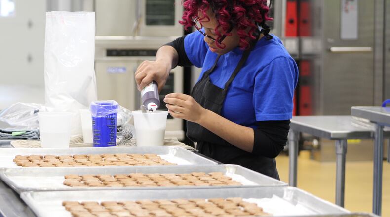 In early 2017, AmeriCorps member Shantel Hart worked at Lindy & Company at 701 S. Patterson Blvd. The business sells 10 different types of gourmet dog treats, which are made by and support homeless youth. CORNELIUS FROLIK / STAFF