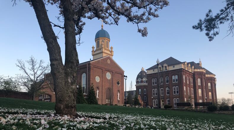 The University of Dayton’s campus — from library lawn, to Chapel of the Immaculate Conception and St. Joseph Hall — sits nearly empty on a recent April day. JEREMY P. KELLEY / STAFF
