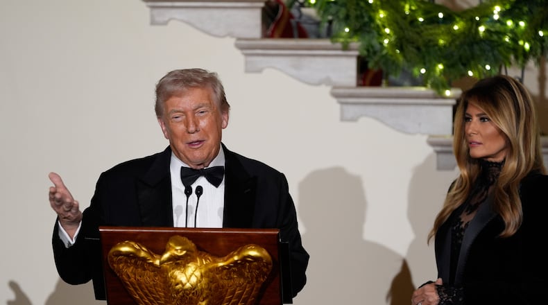 President Donald Trump and first lady Melania greet guests in the Grand Foyer of the White House during the Congressional Ball, Thursday, Dec. 11, 2025, in Washington. (AP Photo/Alex Brandon)