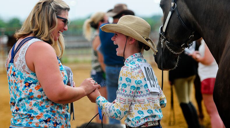 Jami Shell, from Farmersville, congratulates her daughter Liberty Shell, age 10, after winning the Novice Showmanship Competition at the Montgomery County Fair on July 9th, 2024. MARSHALL GOBRY/STAFF