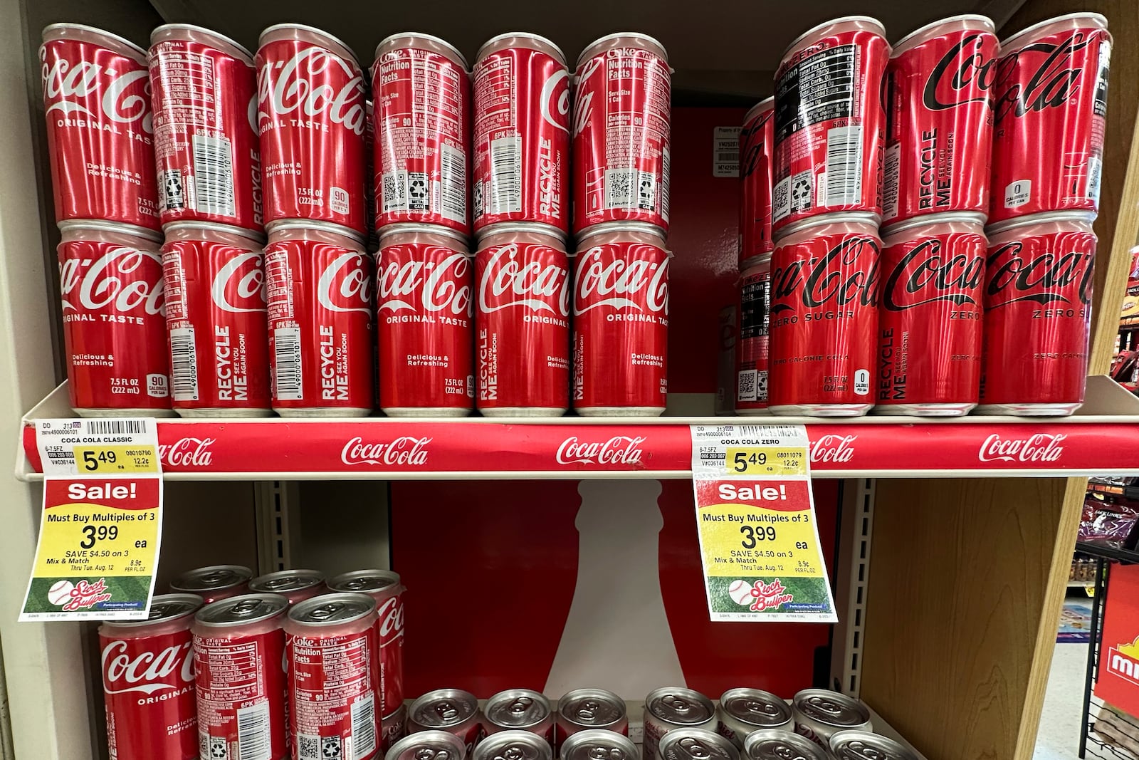 Coca-Cola cans are displayed at a grocery store in Mount Prospect, Ill., Thursday, July 17, 2025. (AP Photo/Nam Y. Huh)