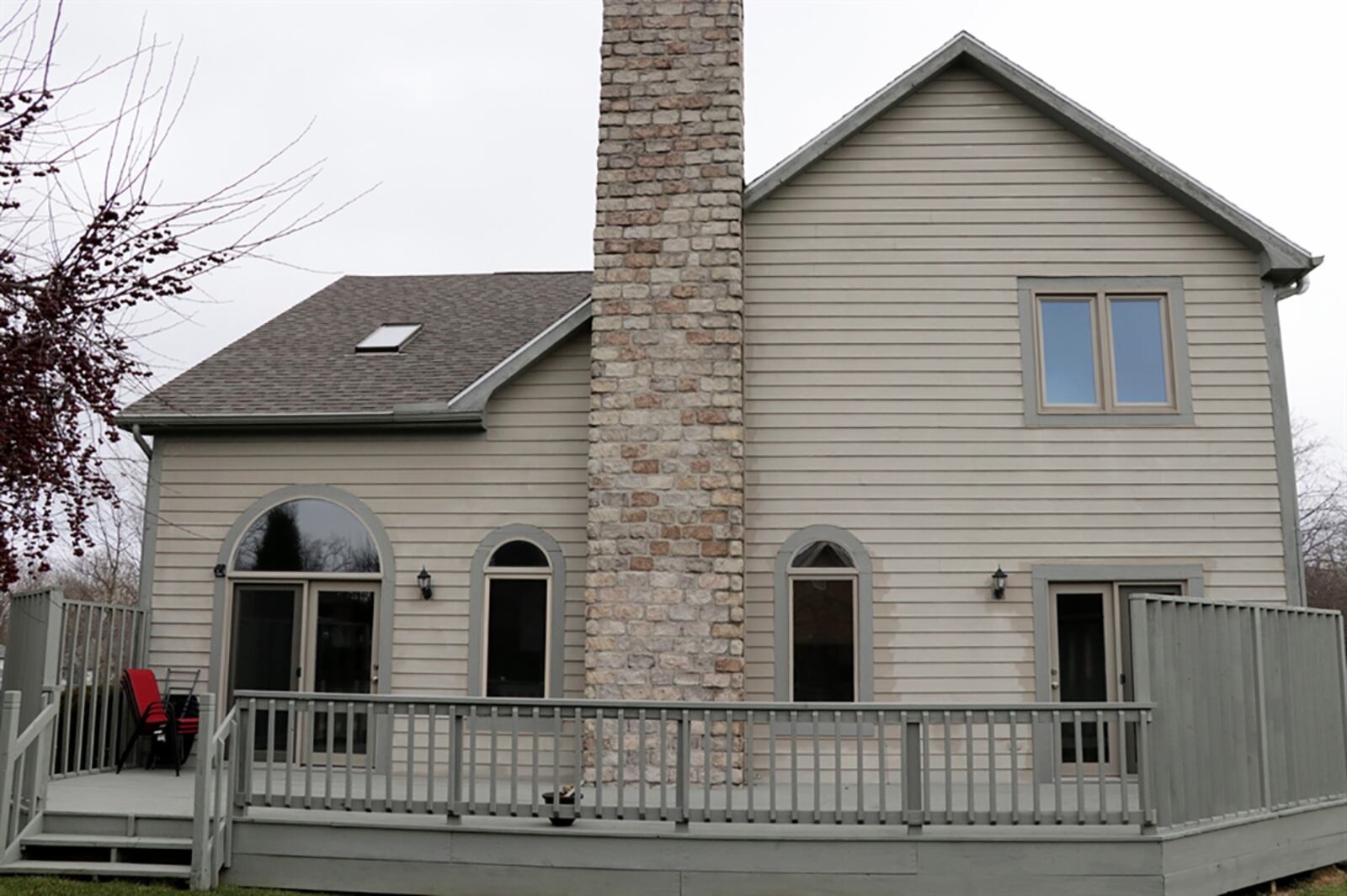 Arched transoms are above patio doors that open from the great room to a wooden deck and back yard. The main bedroom suite also has a door to the deck. CONTRIBUTED PHOTO BY KATHY TYLER