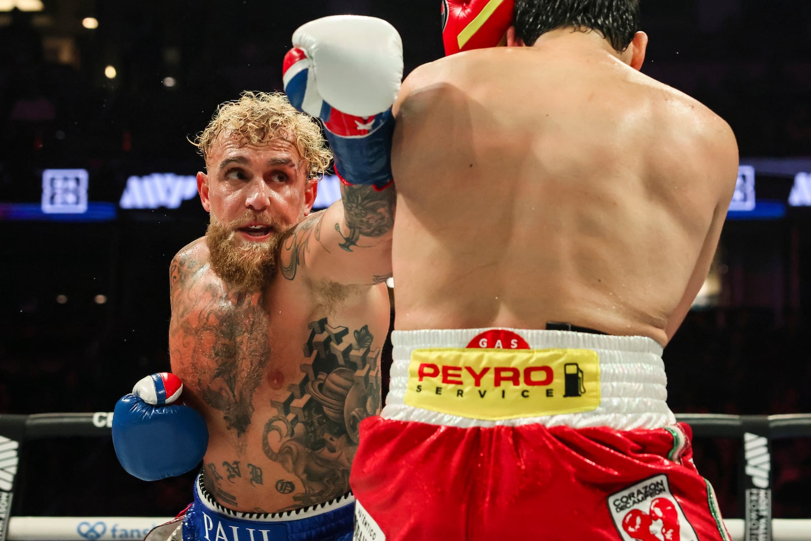 Jake Paul, left, punches Julio Cesar Chavez Jr. during their cruiserweight boxing match on Saturday, June 28, 2025, in Anaheim, Calif. (AP Photo/Etienne Laurent)