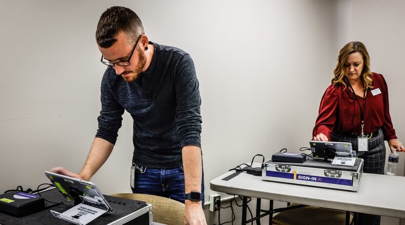 Montgomery County Voter Service Worker, Connor Morrow, left and Deputy Director of the Montgomery County Board of Elections, Sarah W. Greathouse resets training equipment at the board of elections Tuesday October 4, 2022. 
Montgomery County Board of Elections is training 800 poll workers for for the Nov. 8 election. JIM NOELKER/STAFF