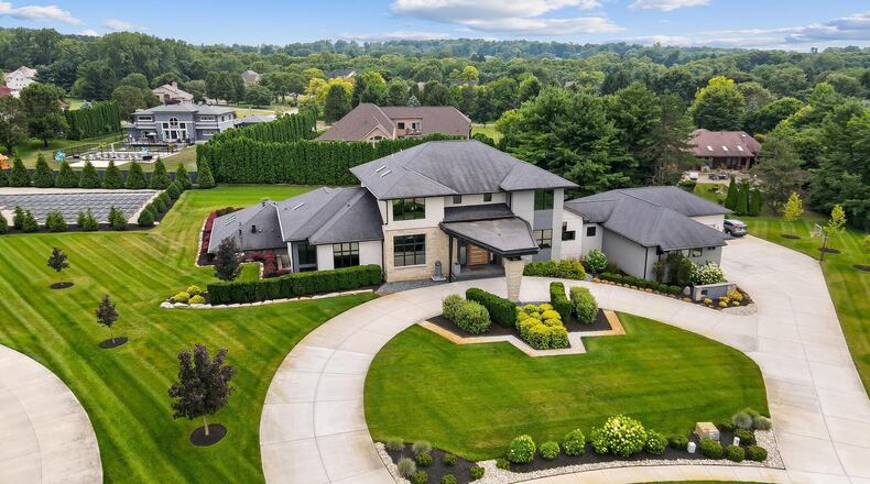 The front of the home has a circular driveway leading to the front of the home and covered front porch as well as the four car attached garage.