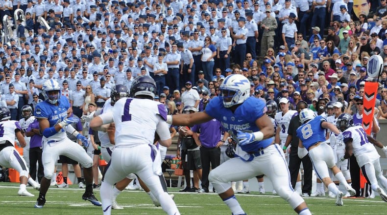 Air Force Academy Defensive End Ryan Watson (right) grabs Abilene Christian University quarterback Dallas Sealey for an eventual sack in this Sept. 3, 2016 game. Watson registered 14.5 sacks in four seasons at defensive end and outside linebacker at the academy and was offered a free agent contract with the Arizona Cardinals in 2017. Now a program manager with Air Force Life Cycle Management Center, Watson has been invited to the Detroit Lions rookie minicamp May 10-13. (U.S. Air Force photo/John Van Winkle).