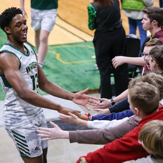 Wright State guard Solomon Callaghan claps hands with fans after a 93-83 victory over Youngstown State on Thursday, Jan. 15 at Ervin J. Nutter Center in Fairborn. BRYANT BILLING/STAFF
