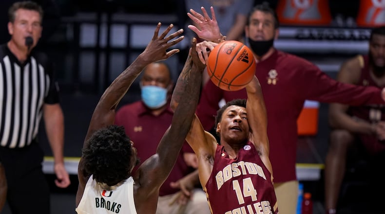 Miami center Nysier Brooks (3) blocks a shot by Boston College forward Kamari Williams (14) during the first half of an NCAA college basketball game, Friday, March 5, 2021, in Coral Gables, Fla. (AP Photo/Wilfredo Lee)