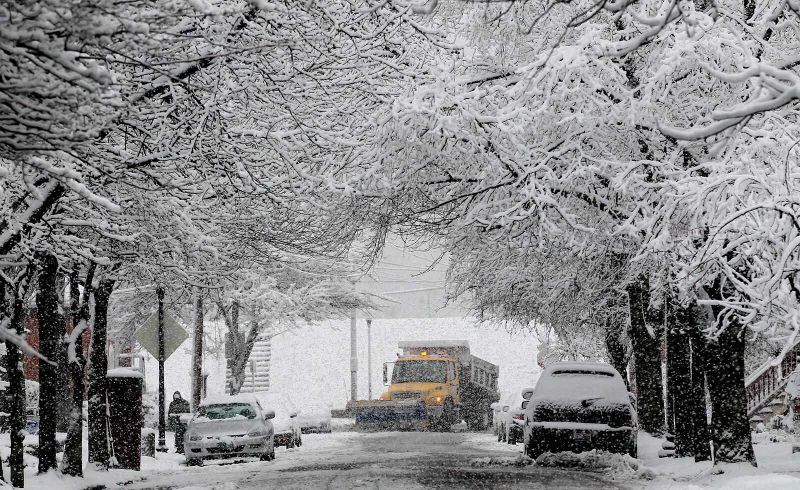 A Dayton snow plow driver works the area around Riverview Avenue and McDaniel Street early Monday, March 25, 2013, cleaning up after an early spring snow. The official snowfall total in Dayton on Sunday was 5.8 inches, as measured at the Dayton International Airport. That breaks the daily record for March 24 which was previously 4 inches set in 1912. CHRIS STEWART / STAFF