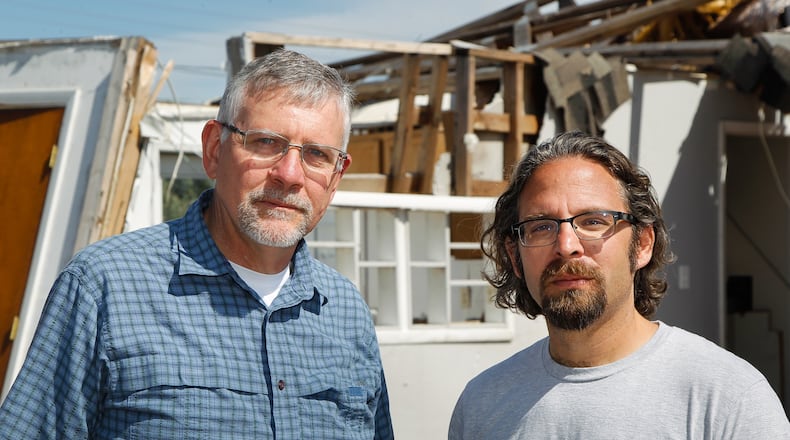 Dayton Daily News reporters Chris Stewart, left, and Josh Sweigart are retracing the path of a devastating EF4 Memorial Day tornado that cut across Montgomery County. CHUCK HAMLIN / STAFF
