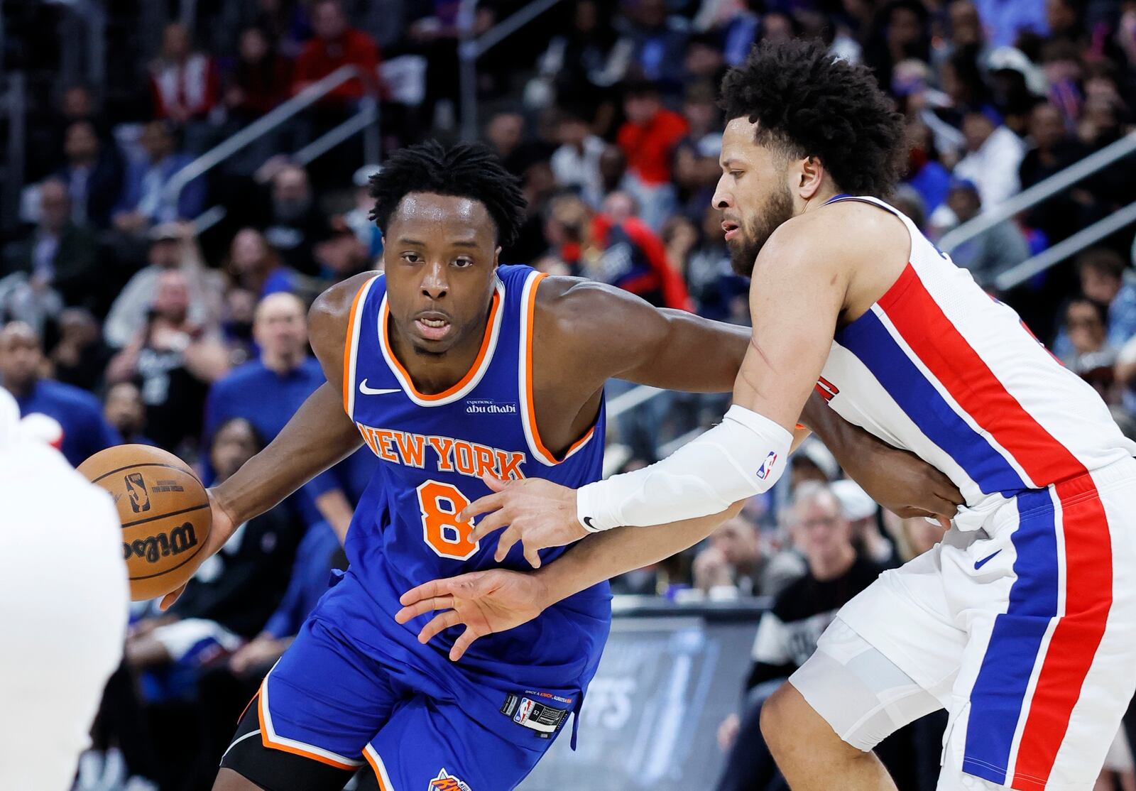 New York Knicks forward OG Anunoby (8) drives to the basket against Detroit Pistons guard Cade Cunningham, right, during the first half of Game 4 of an NBA basketball first-round playoff series Sunday, April 27, 2025, in Detroit. (AP Photo/Duane Burleson)