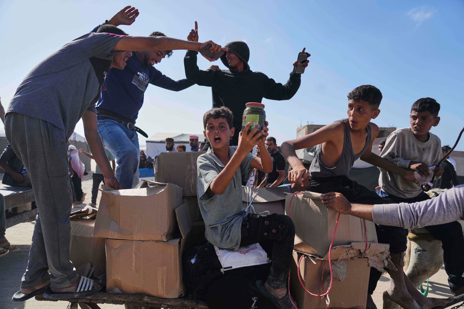 FILE - Palestinians carry boxes containing food and humanitarian aid packages delivered by the Gaza Humanitarian Foundation, a U.S.-backed organization approved by Israel, in Rafah, southern Gaza Strip, Tuesday, May 27, 2025. (AP Photo/Abdel Kareem Hana,File)