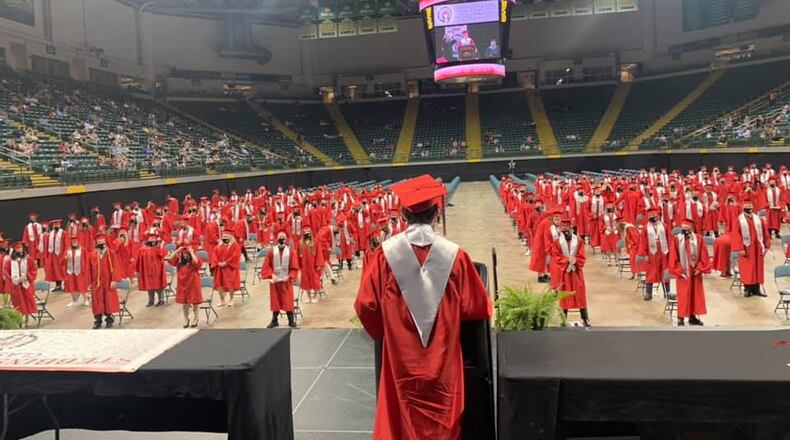 Members of the Stebbins High School Class of 2021 stand for a speech at their graduation ceremony at the Nutter Center. Contributed photo by Mad River Local Schools
