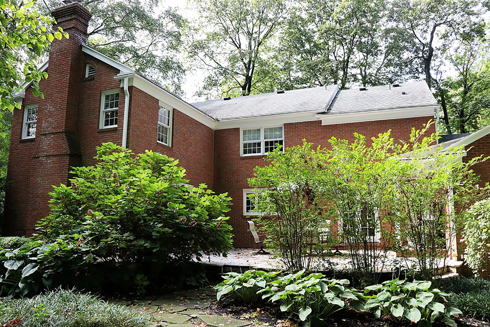 A walkway wraps from the driveway to the more casual covered back entry. 
Surrounded by trees, the flagstone patio is elevated and shaded while the remaining yard has mature landscaping and tree islands. CONTRIBUTED PHOTO BY KATHY TYLER
