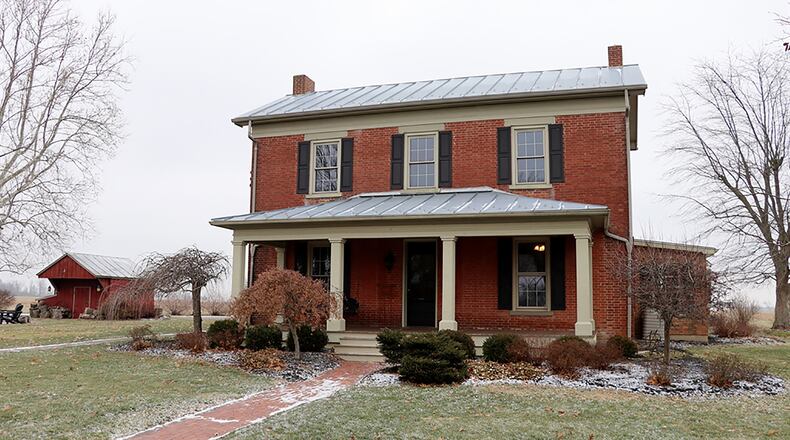 The brick farmhouse is one of five buildings on the 11-acre property. The 3-bedroom home has 3,120 sq. ft. of living space with a sun room and update kitchen and baths. CONTRIBUTED PHOTO BY KATHY TYLER