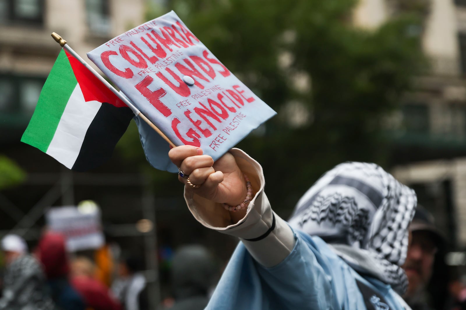 A graduate shows off their decorated cap in support of Palestinians while rallying across the street from the main gates of Columbia University, Wednesday, May 21, 2025, in New York. (AP Photo/Heather Khalifa)