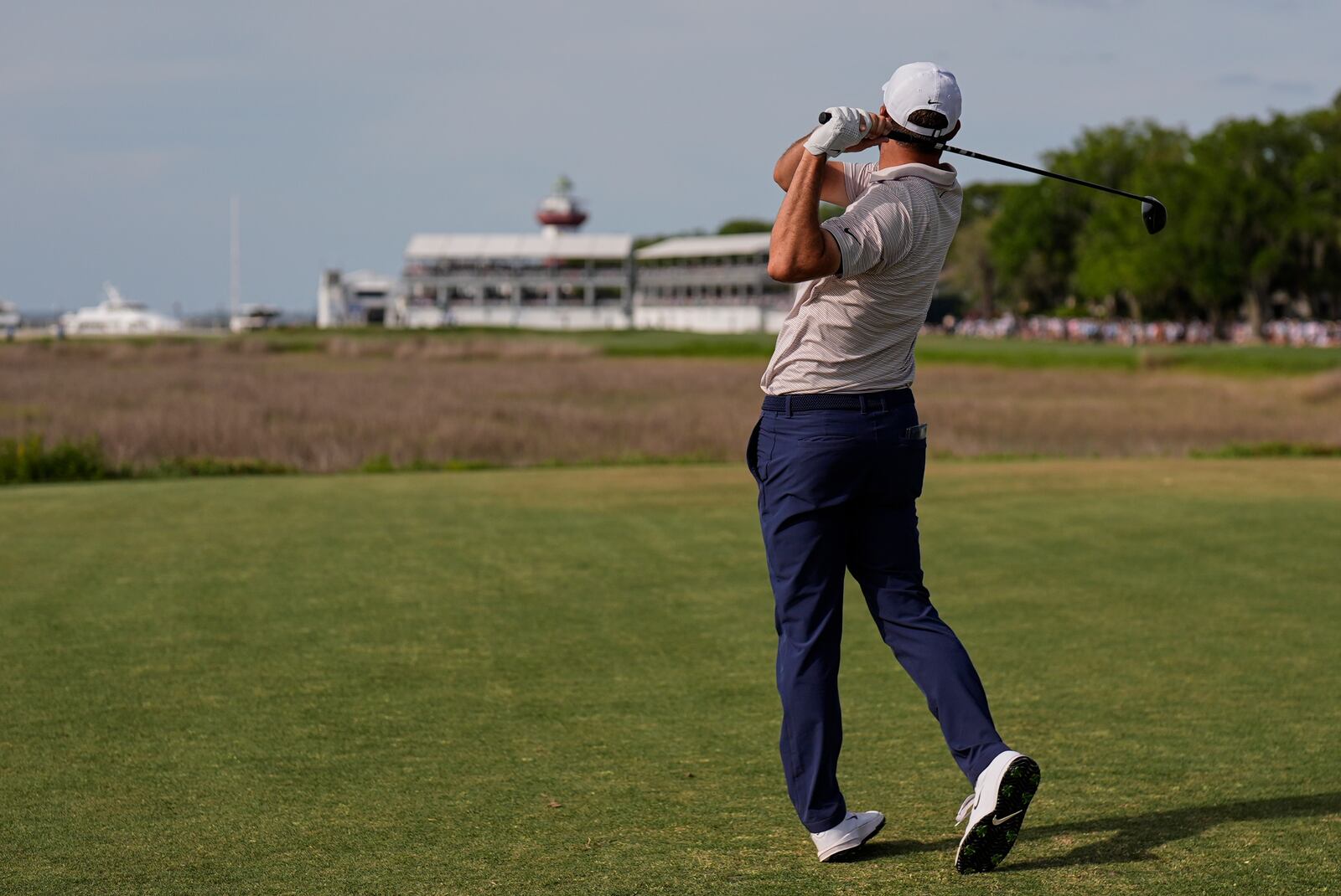 Scottie Scheffler watches his drive from the 18th tee during the final round of the RBC Heritage golf tournament, Sunday, April 20, 2025, in Hilton Head Island, S.C. (AP Photo/Mike Stewart)
