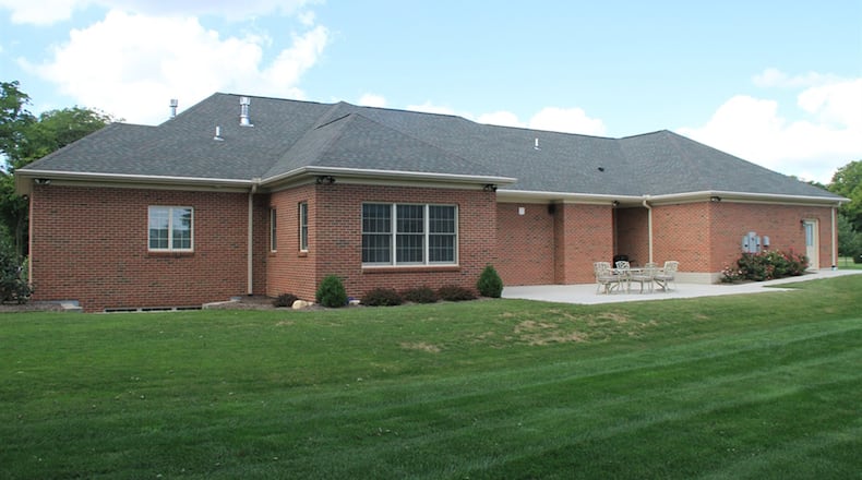 Off the dining room is a morning room with several windows and patio doors that open to a concrete patio. Surround-sound system includes both interior and exterior speakers.