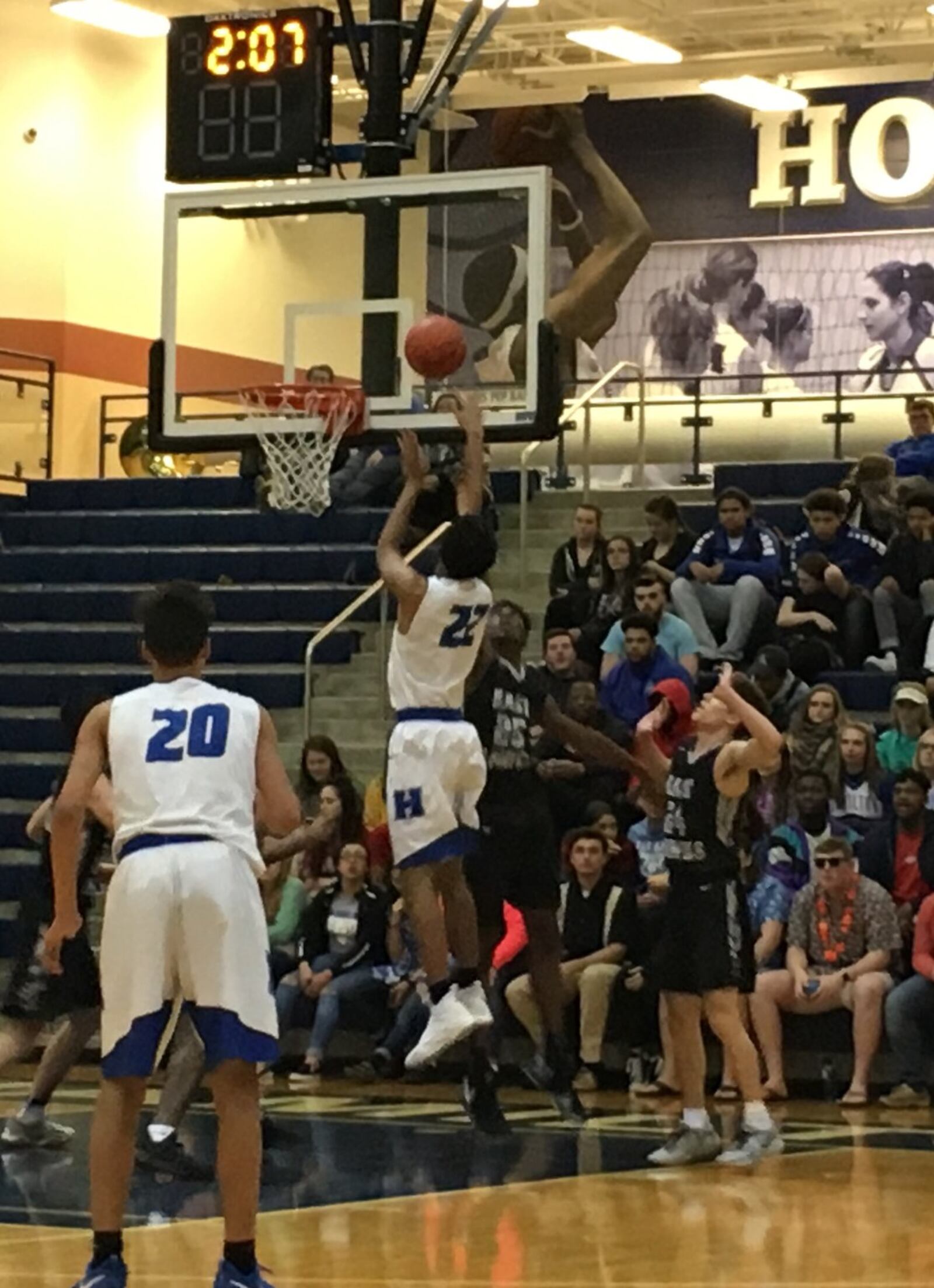 Hamilton’s Cameron Benson (22) shoots over Kyrell Metts (25) of Lakota East during Friday night’s game at the Hamilton Athletic Center. Big Blue’s Trey Robinson (20) and the Thunderhawks’ Will Johnston (24) are watching the play. RICK CASSANO/STAFF