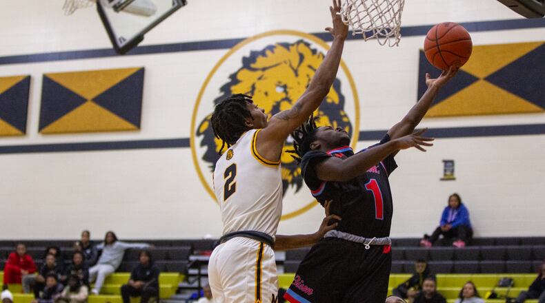 Belmont senior Da'Marion Calahan scores two of his 32 points against Meadowdale's Quentin Jones during Belmont's 77-58 victory Friday night at Meadowdale. Jeff Gilbert/CONTRIBUTED