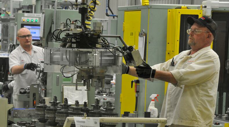 Honda associates work on the assembly line at the Honda Transmission Manufacturing plant in Russells Point in this 2013 file photo. Bill Lackey/Staff