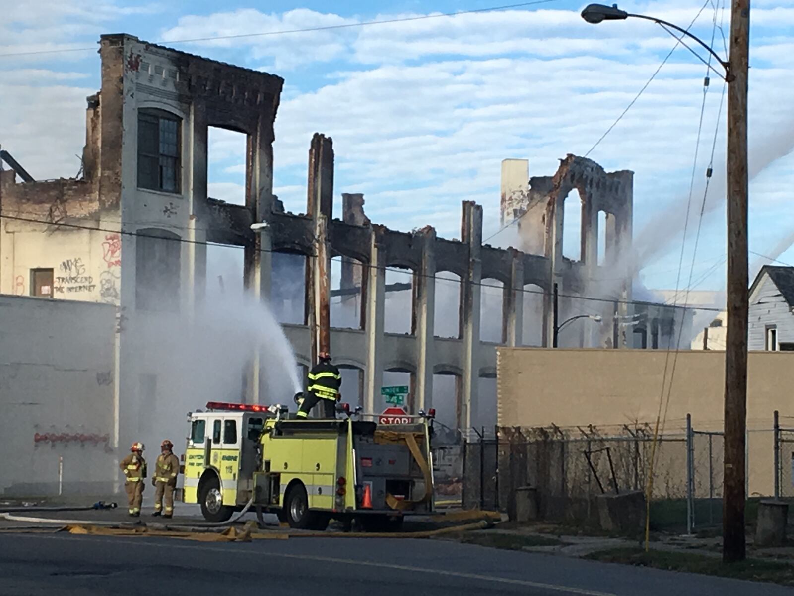 Crews work to hose down parts of the former Hewitt Soap Factory after the Linden Avenue structure caught fire. CORY FROLIK/STAFF PHOTO