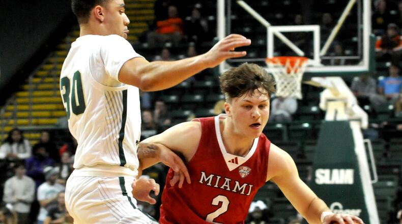 Miami's Evan Ipsaro, 2, drives past Wright State's Kaden Brown, 30, during a nonconference game at Wright State's Nutter Center on Tuesday, Dec. 19, 2023. DAVID A. MOODIE/CONTRIBUTING PHOTOGRAPHER
