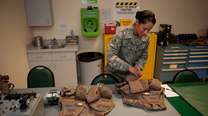 Airman 1st Class Jennifer Lopez, 379th Expeditionary Operations Support Squadron aircrew flight equipment journeyman, prepares and checks survival vests prior to being issued to a B-1B Lancer aircrew in southwest Asia. (U.S. Air Force photo/Staff Sgt. Sharon Singer)