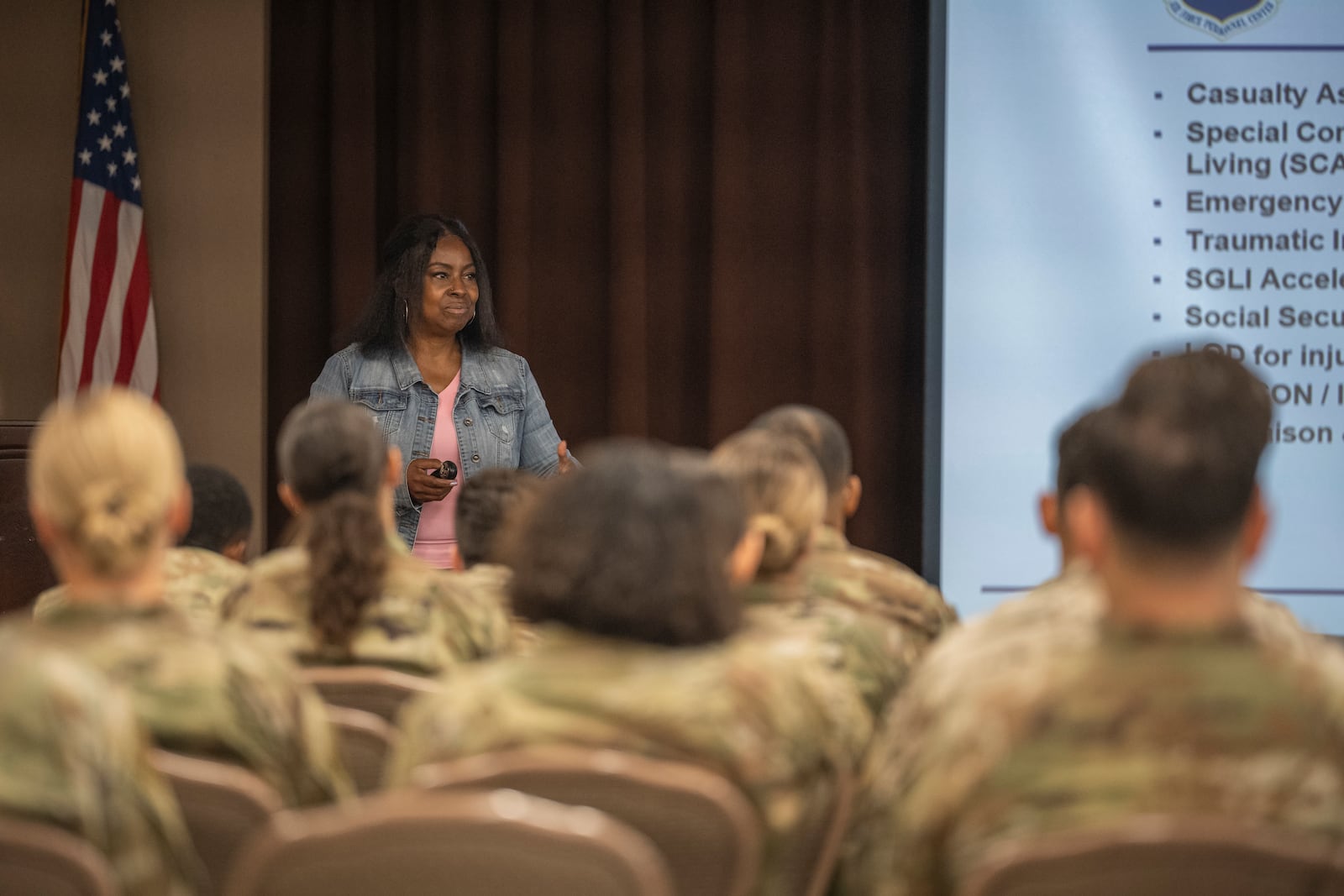 Adrienne Clark, 88th Medical Group recovery care coordinator, briefs Airmen and Guardians on the Wounded Warrior Program during the Wright Start Program the Wright-Patt Club on Wright-Patterson Air Force Base, July 9, 2024. Air Force photo by Ashley Richards