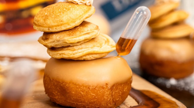 Death Grip Donuts is collaborating with Uncle Boof’s World Famous Pancake Mix for a “Locals Only” donut featuring a traditional vanilla donut with maple glaze, three mini pancakes and a dollop of cinnamon butter that’s served with a pipette of maple syrup (Photo Courtesy: Shutter Steve Photography).