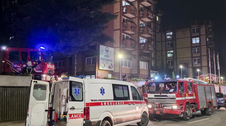 A rescue cars are parked in front of a nursing home after a fire in Tuzla, Bosnia, Tuesday, Nov. 4, 2025. (AP Photo)