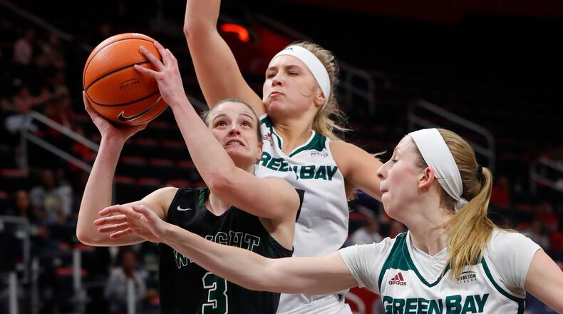 Wright State guard Emily Vogelpohl (3) drives on Green Bay guard Allie LeClaire (24) and Jessica Lindstrom during the first half of an NCAA women’s basketball game in the Horizon League conference tournament championship in Detroit, Tuesday, March 6, 2018. (AP Photo/Paul Sancya)