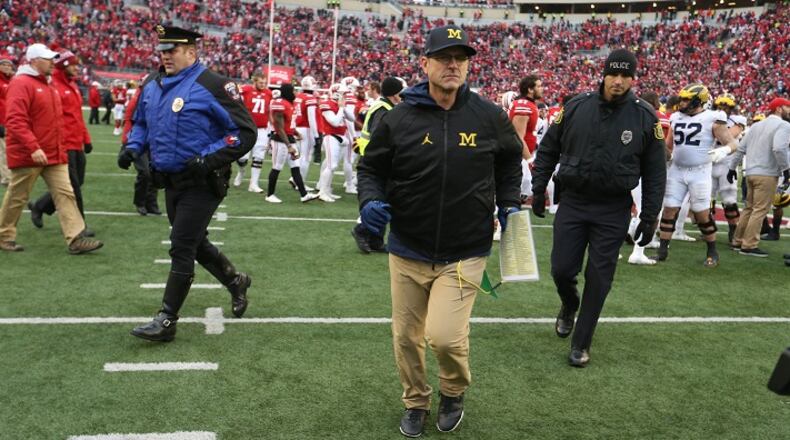 Michigan head coach Jim Harbaugh leaves the field after the 24-10 loss to Wisconsin Saturday, Nov. 18, 2017 at Camp Randall Stadium in Madison, Wis. (Kirthmon F. Dozier/Detroit Free Press/TNS)