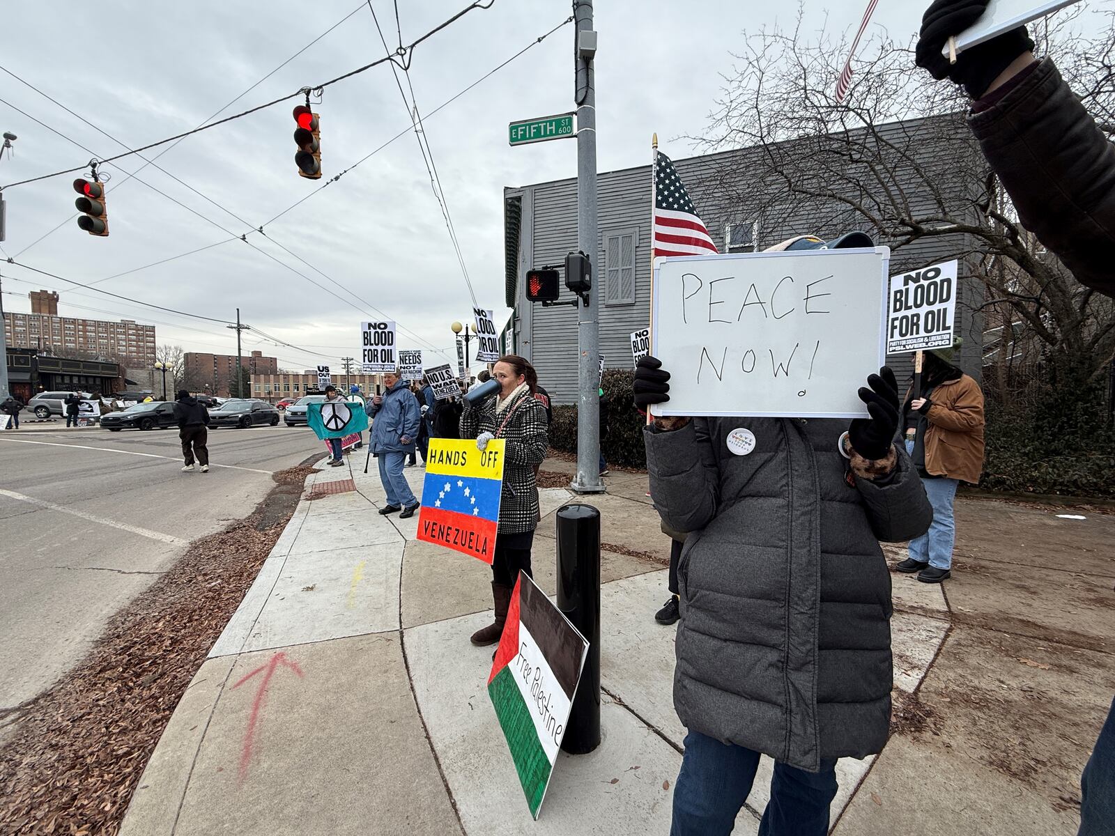 Protestors gathered in the Oregon District in downtown Dayton to condemn U.S. action against Venezuela. CORNELIUS FROLIK / STAFF