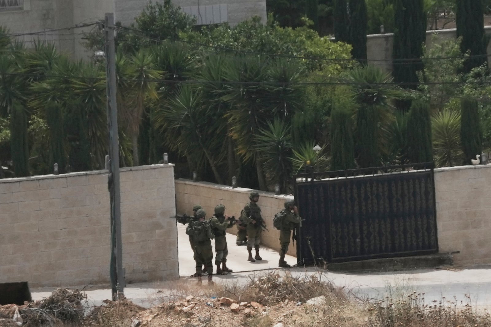 Israeli soldiers search a Palestinian village next to the West Bank settlement of Bruchin, the morning after a Palestinian gunman shooting killed Tzeela Gez, who was on her way to the hospital to give birth, Thursday, May 15, 2025. (AP Photo/Maya Alleruzzo)