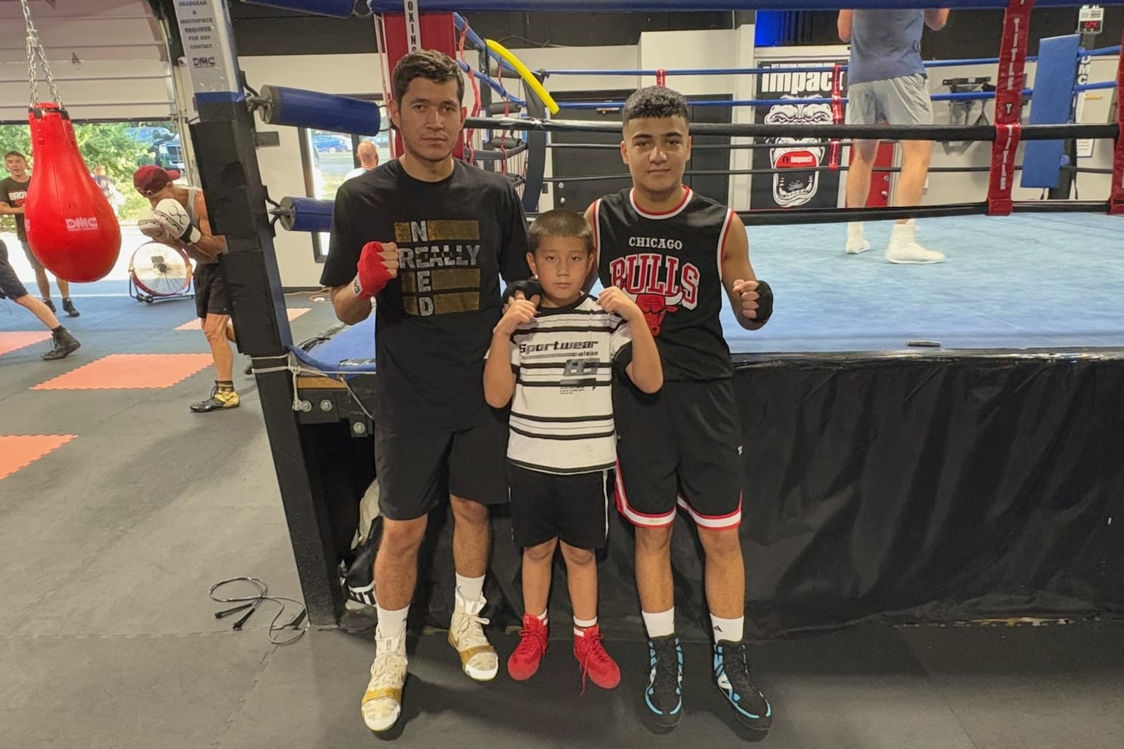 A trio of boxers from Uzbekistan: Murodjon Eshnazarov, a 20-year-old University of Cincinnati student, 8-year-old Shakavoz Eshnagov and 14-year-old Davlat Yunosov, a freshman at Miamisburg High. TOM ARCHDEACON/CONTRIBUTED PHOTO