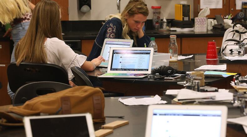 Students work on laptop computers at the Global Impact STEM Academy. Bill Lackey/Staff