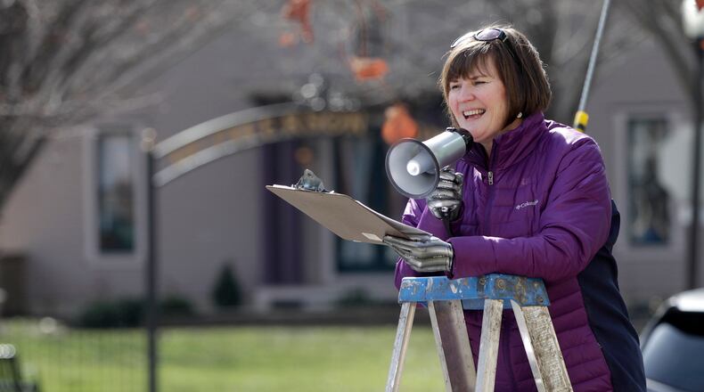 McPherson Town Historic District neighborhood resident Donna LaChance led more than 25 people of all ages in a game of outdoor Simon Says. LISA POWELL / STAFF