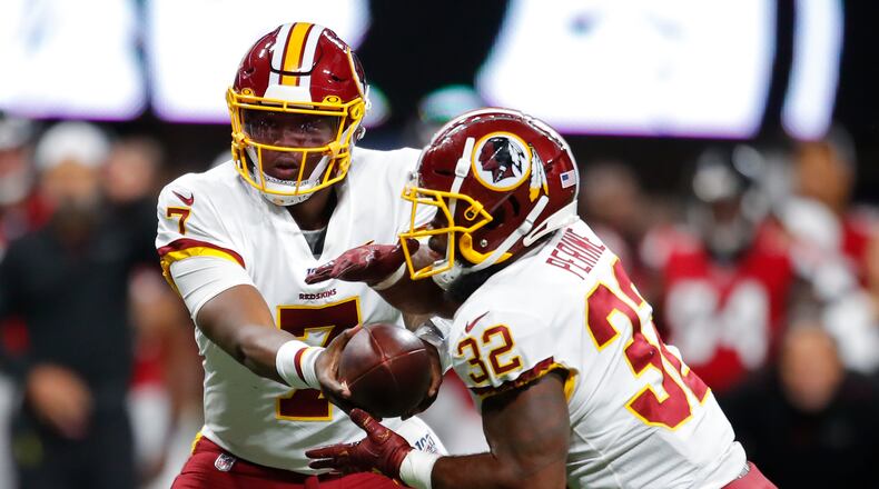 ATLANTA, GA - AUGUST 22: Quarterback Dwayne Haskins #7 of the Washington Redskins hands off to running back Samaje Perine #32 in the second half of an NFL preseason game against the Atlanta Falcons at Mercedes-Benz Stadium on August 22, 2019 in Atlanta, Georgia. (Photo by Todd Kirkland/Getty Images)